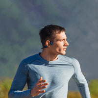 man exercising wearing Shokz OpenRun running headphones in blue and black