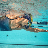 A swimmer wearing the Aquasphere focus snorkel in navy blue.