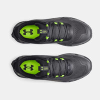 A pair of Under Armour charged bandit tr2 jet grey running shoes.