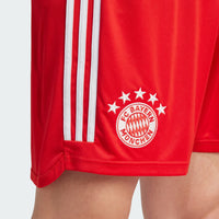 adult 23/24 Bayern Munich home kit shorts from adidas - red. Close up of the crest on the shorts