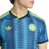 Blue sports jersey with yellow accents and a logo on a white background