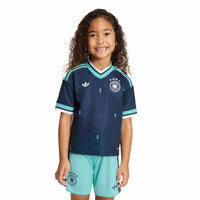 Child modelling the Germany '26 Away Football Mini Kit