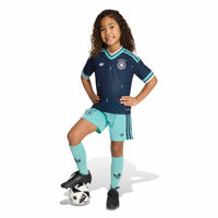Child modelling the Germany '26 Away Football Mini Kit