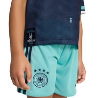 Child modelling the Germany '26 Away Football Mini Kit shorts