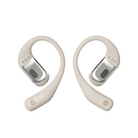 A beige pair of Shokz openfit bone conduction headphones.