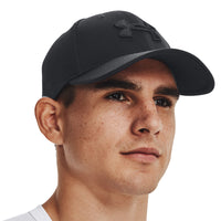 A person wearing the under armour men's blitzing cap in black.