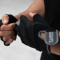 person putting on Urban Fitness Pro Gel training gloves