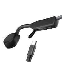 Shokz OpenMove sports headphones in grey showing charger port
