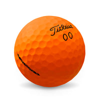 A Titleist Velocity 2022 golf ball in ora